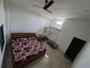 a bedroom with a bed and a ceiling fan at VnM Paradise in Chunār