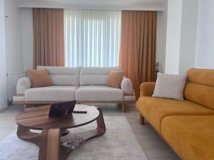 a living room with a couch and a coffee table at Taner Berk Apart 4 in Antalya
