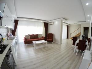 a living room with a couch and a table at Taner Berk Apart 4 in Antalya