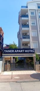 a white building with a sign that reads tener apart hotel at Taner Berk Apart 4 in Antalya