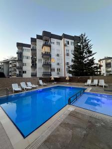 a large swimming pool in front of a building at Taner Berk Apart 4 in Antalya
