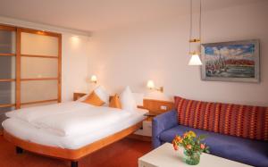 a hotel room with a bed and a couch at Hanseat in Helgoland