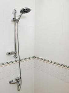 a shower with a shower head in a bathroom at Altavista mountain apartment in Samokov +63 photos
