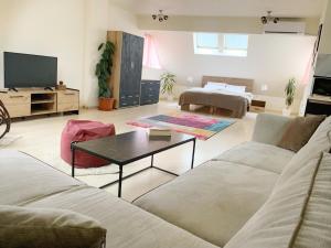 a living room with a couch and a coffee table at Altavista mountain apartment in Samokov