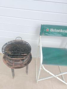a chair and a grill next to a box at Cabaña Mañihueico in Hualaihué +1 photo