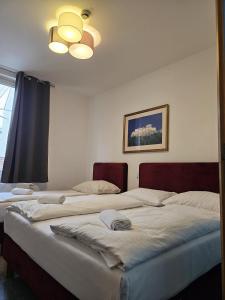 two beds sitting next to each other in a bedroom at Hotel Astral Vienna in Vienna