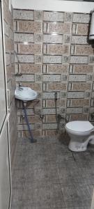 a bathroom with a sink and a toilet at Mount view guest house in Mukteshwar