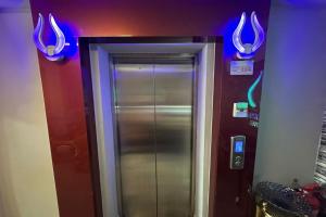 a elevator in a room with purple lights at Poorna Hotel at Jalan Ipoh Sentul Kuala Lumpur in Kuala Lumpur