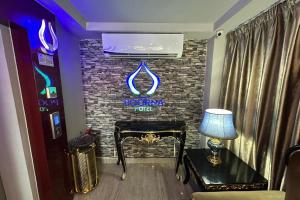a room with a fireplace and a sign on a brick wall at Poorna Hotel at Jalan Ipoh Sentul Kuala Lumpur in Kuala Lumpur