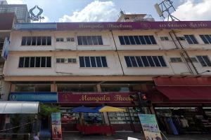 a large building with a sign on the side of it at Poorna Hotel at Jalan Ipoh Sentul Kuala Lumpur in Kuala Lumpur