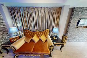 a couch in a living room with a large window at Poorna Hotel at Jalan Ipoh Sentul Kuala Lumpur in Kuala Lumpur