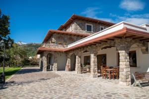 a house with a porch and a patio at Agriturismo Cupello in Cagnano Amiterno