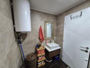 a bathroom with a sink and a mirror at Avram in Vrnjci