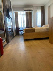 a hotel room with a bed and a table at Güven Suit Otel in Istanbul