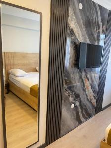a mirror in a room with a bed and a tv at Güven Suit Otel in Istanbul +16 photos