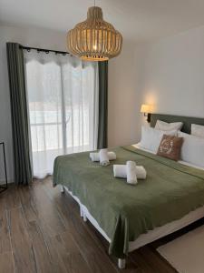 a bedroom with a large bed with two towels at Villa Arbevhio in Bonifacio +55 photos