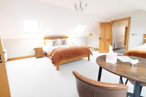 a bedroom with a bed and a table in it at Edenmore Cottage Bed & Breakfast in Moorefield