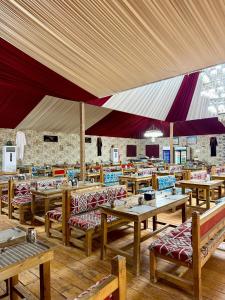 a restaurant with tables and chairs and a large tent at Rum Oasis Luxury Camp in Wadi Rum