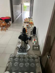 a long table with plates of food on it at Hotel Master Plaza Formiga in Formiga
