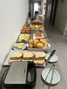 a buffet line with sandwiches and other food items at Hotel Master Plaza Formiga in Formiga +17 photos