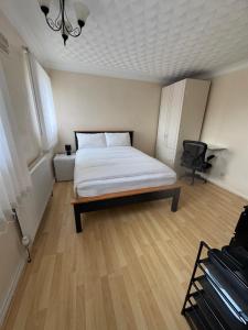 a bedroom with a bed and a chair in it at Hawkins Guesthouse in Milton