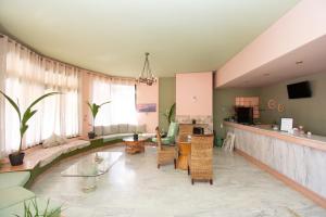 a living room with a couch and a table at Aquarius Apartments "by Checkin" in Agia Pelagia