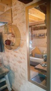 a mirror reflection of a living room with a couch at La Casita de Lledó in Vilafamés