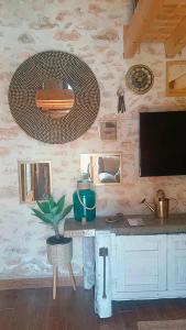 a room with a desk and a wall with pictures at La Casita de Lledó in Vilafamés
