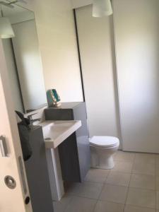 a bathroom with a white toilet and a sink at Les ferrajals in Rouvenac +9 photos