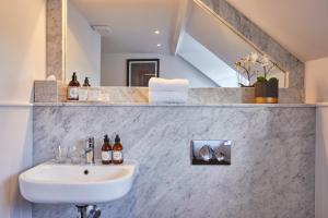 a bathroom with a sink and a mirror at The Swan in Wedmore +65 photos