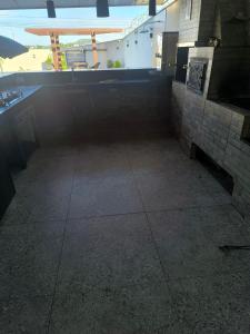 a dark room with a tile floor and a window at Espaço de eventos dorneles in Senador Canedo