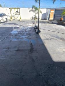 a parking lot with puddles of water on the street at Espaço de eventos dorneles in Senador Canedo