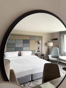 a hotel room with a bed and a mirror at Cabarfeidh Hotel in Stornoway +90 photos