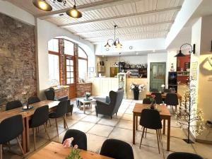 a restaurant with tables and chairs in a room at Dvůr Stráň & Wellness in Karlovy Vary