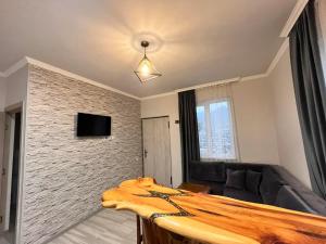 a living room with a table and a couch at Gogasar house in Ijevan