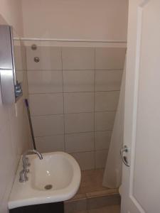 a small bathroom with a sink and a shower at Casa 1 in Rincon de los Sauces
