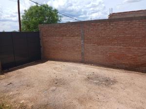 a brick wall with a gate in front of it at Casa 1 in Rincon de los Sauces