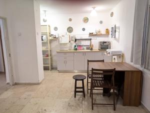 a kitchen with a table and chairs and a counter at Old City Charm in Beer Sheva