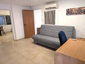 a living room with a couch and a table at Old City Charm in Beer Sheva