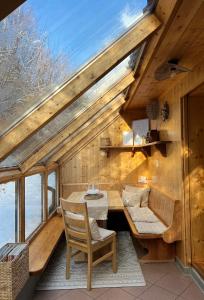 a wooden cabin with a table and a chair at Umundumhütte in Katsch an der Mur