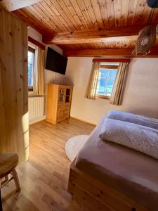 a bedroom with two beds and a television in it at Umundumhütte in Katsch an der Mur