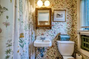 a bathroom with a sink and a toilet and a mirror at Highland Ave in Norwalk
