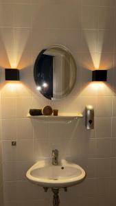a bathroom with a sink and a mirror at AhA in Lingen