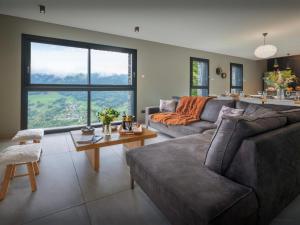 a living room with a couch and a table at Chalet Confidentiel - OVO Network in Doucy +16 photos