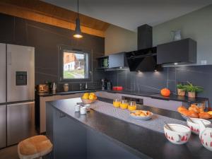 a kitchen with a counter with oranges on it at Chalet Confidentiel - OVO Network in Doucy