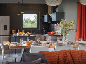 a kitchen with a wooden table and a dining room at Chalet Confidentiel - OVO Network in Doucy