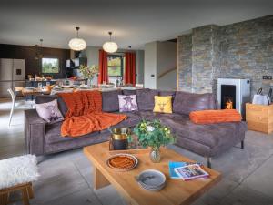 a living room with a couch and a table at Chalet Confidentiel - OVO Network in Doucy