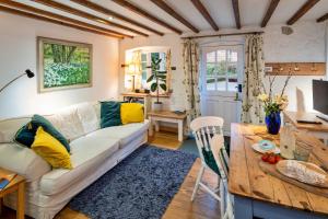 a living room with a couch and a table at Finest Retreats - Little Roost in Lyme Regis
