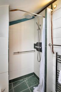 a shower with a glass door in a bathroom at Finest Retreats - Little Roost in Lyme Regis +7 photos