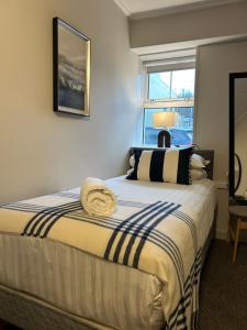 a bedroom with a large bed with a window at Westport Rooms in Westport